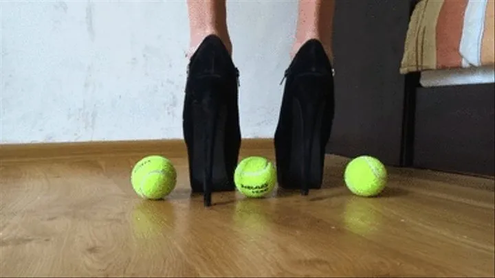 Trampling tennis balls with my black ankle boots - close view