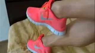 Playing with my nike pink free run sneakers on the bed and taking them off