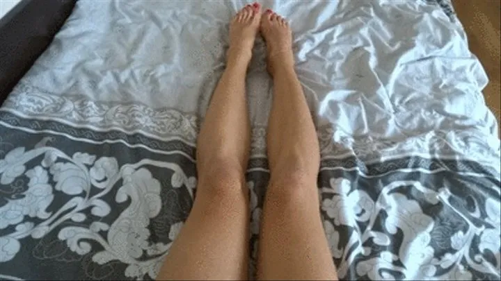 Leg playing on the bed plus red nails and anklets - higher view