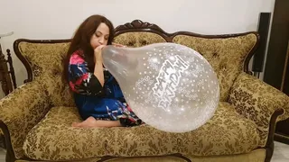 Nathalie Blows To Pop Clear Balloon