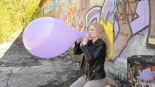 Katya Blows To Pop Purple Balloon Outdoor