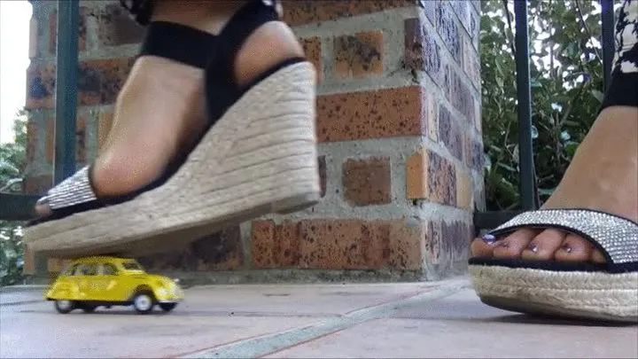 Natasha crushes a yellow toy car and plays with her shoes