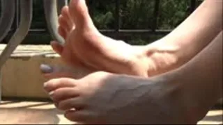 Christine wiggles her small feet on a balcony part 2