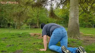 Rubber boot mistress presses slave face into straw