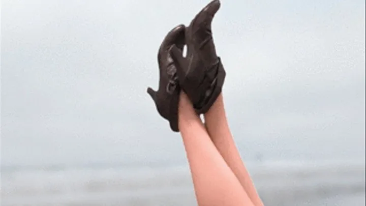 Woman Kickin' It At The Beach In High-Heeled Boots