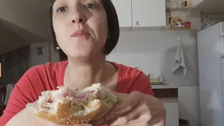 fixing a sandwich and eating it