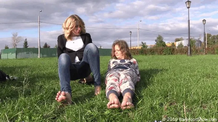 Assol and Kseniya show their soles on the grass (Part 3 of 3)