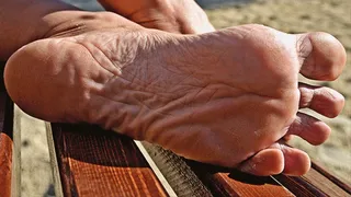 Barefoot mature Olga shows wrinkled soles on a public beach (Part 5 of 6)