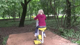 Glamor blonde barefoot in a sports park (Full)