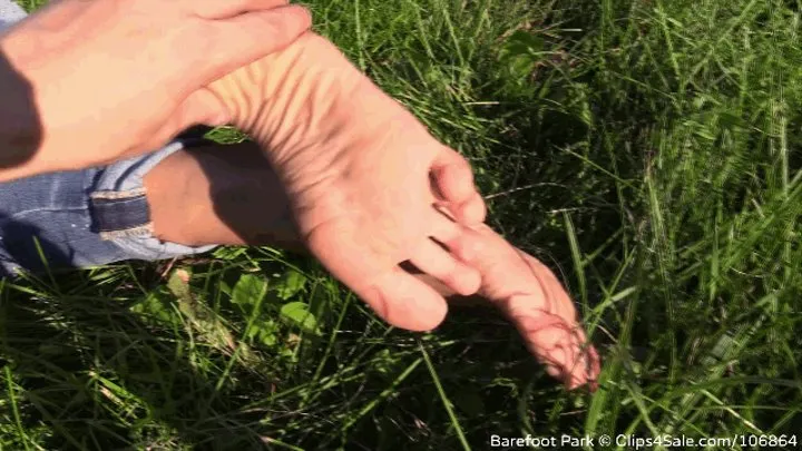 Mature barefoot Eva makes foot show on the grass (Part 3 of 6)