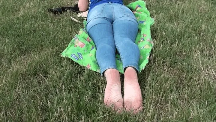 Cute blonde shows her big feet on the grass (Part 2)