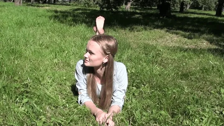 Young slim beautiful barefoot in sunny park (Part 4)