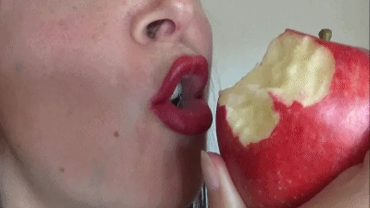 Teasing and eating delicious Red Apple wearing lipstick