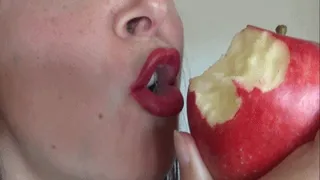 Teasing and eating delicious Red Apple wearing lipstick
