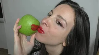 Red lipstick on green apple