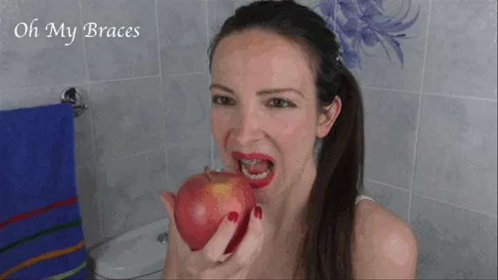 Biting and eating an apple with braces