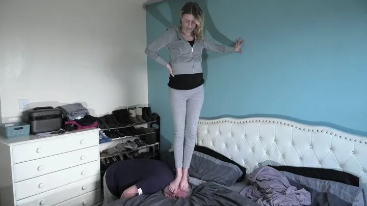 Head Trampling On The Bed In Leggings