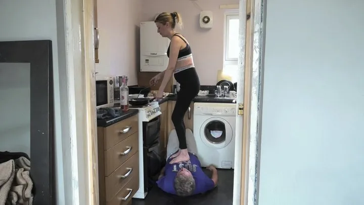 Cooking A Meal For The Family Whilst Stepping On Him Bare Foot