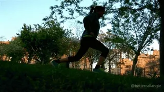 Doing lunges in a public park at sunset, voyeur clip from the grass