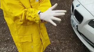 Laura washes a car in rubber jacket, rubberboots and rubber gloves- 35