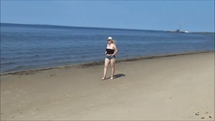 Big ass in denim shorts on the beach