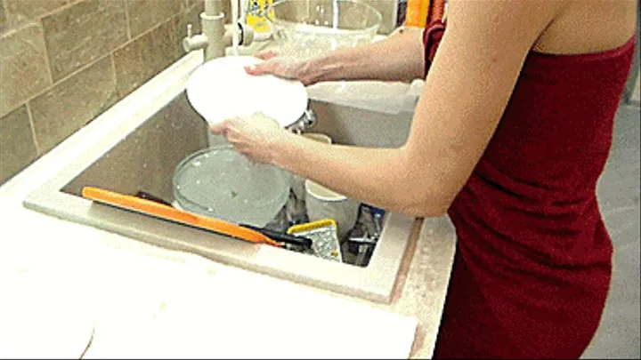 A young brunette cleans up the kitchen.