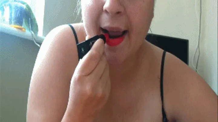 Sucking on a dildo with red lipstick