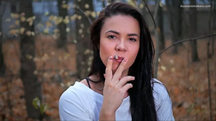 Gorgeous fitness trainer Tanya is smoking a cigarette in the park