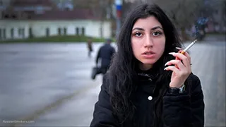 A big-eyed girl is smoking 100s Marlboro Red