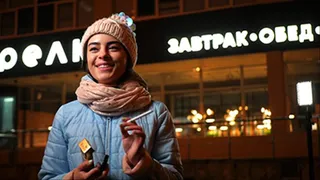 Lovely Russian girl Karina smokes a cigarette in the cold outside