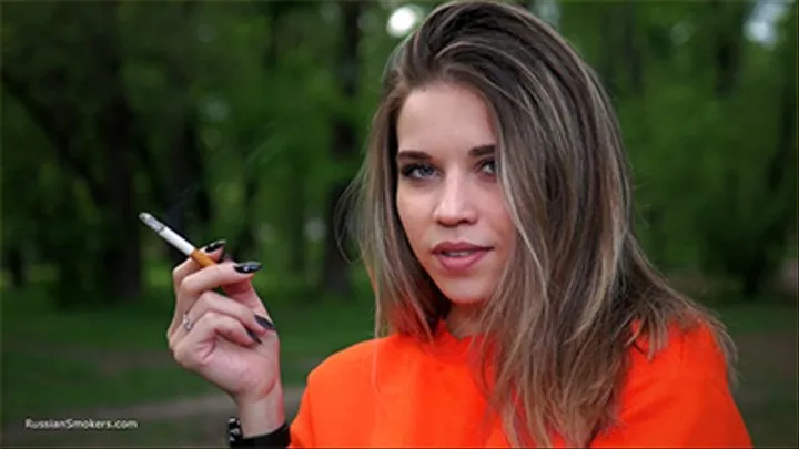 Pretty Kate is smoking Marlboro Red 100s in the park