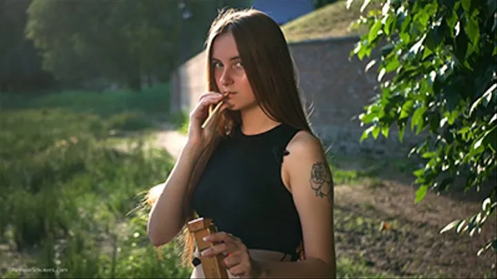 18 years old Margarita is smoking three cork 120mm cigarettes outdoors