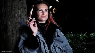 Mature woman smoking outdoors