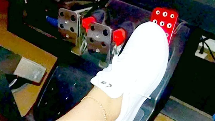 White Nike Tanjuns on the racing simulator