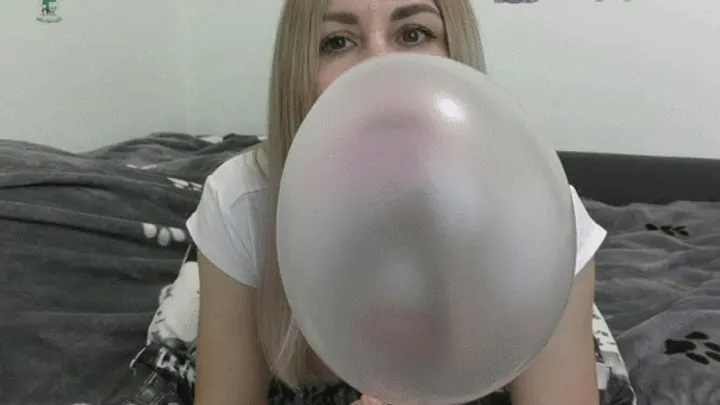 Look at me and blow huge, thick, pink bubbles until they burst