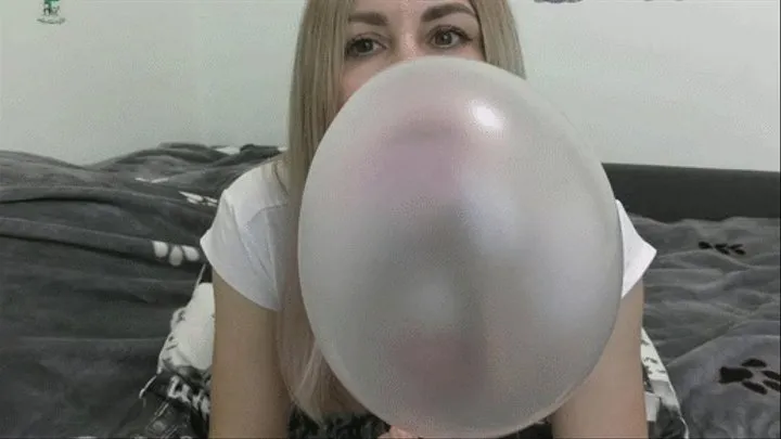 Look at me and blow huge, thick, pink bubbles until they burst