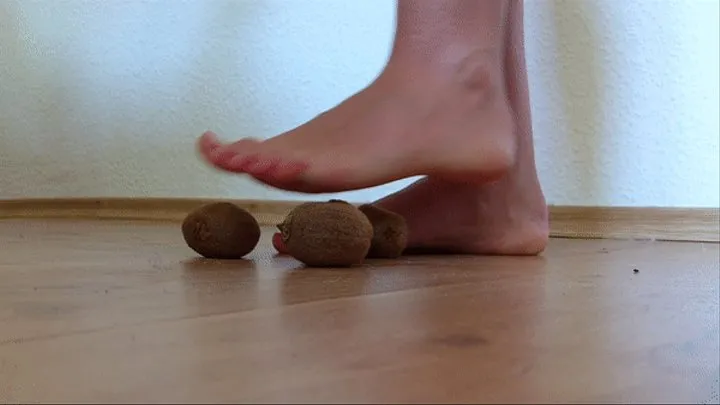 Crushed kiwi with bare feet. Dominance of feet