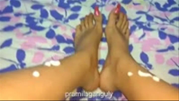 Applying Lotion on Feet with Sparkling Pink Toenails