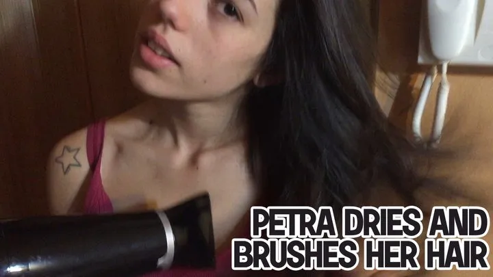 Petra dries and brushes her hair