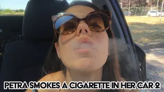 Petra smokes a cigarette in her car 2