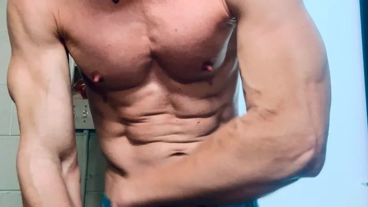 Up close flexing with ripped abs and bulging veins