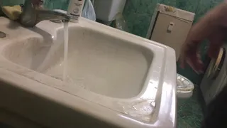 Unclogging the sink using two plungers!