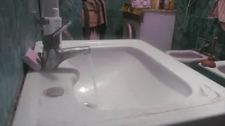 Unclogging the sink, making a lot of water noise!