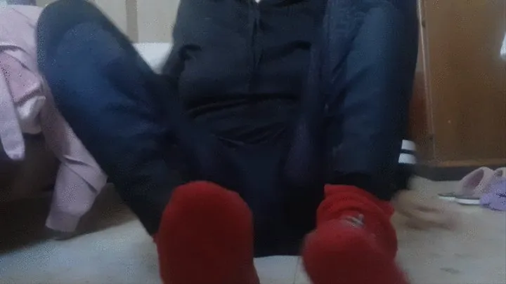 SCRATCHING FEET THROUGH RED SOCKS