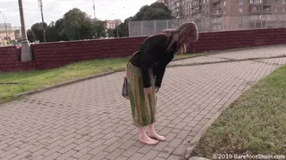 Mature hippie girl Olga walks barefoot in a dirty city on a rainy day (Full)
