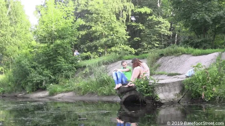 Two beauties Anastasia and Lily barefoot in a city park (Part 1 of 5)