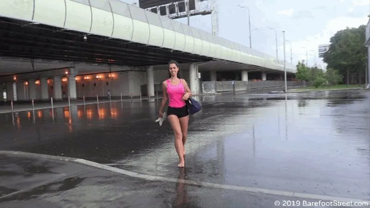 Olivia is having fun on the asphalt under the summer rain