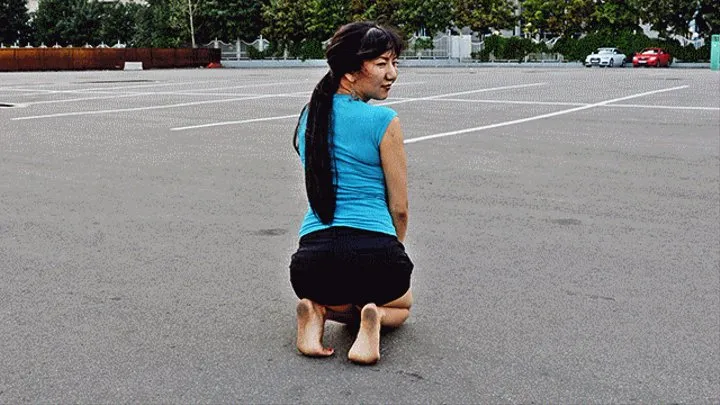 Cute oriental girl Ainura barefoot in a dirty parking (Part 5 of 6)