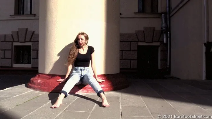 Young beautiful singer Anna walks barefoot along the sunny city streets (Part 2 of 6)