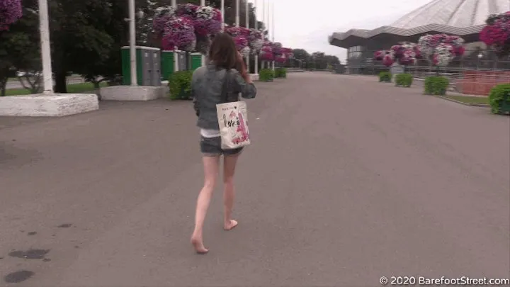 Serious girl Margo walks barefoot in the city on a cloudy day (Part 1 of 6)